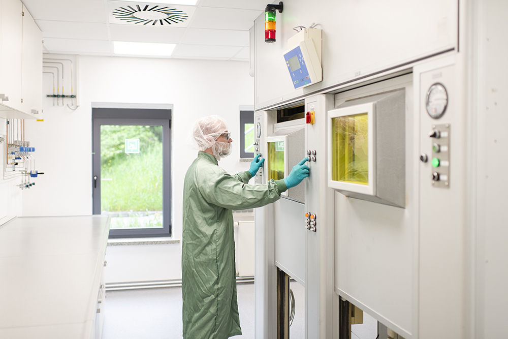 A technician operates fully shielded hot cells in a dedicated suite, showcasing cutting-edge CDMO services and supporting radiopharma R&D.